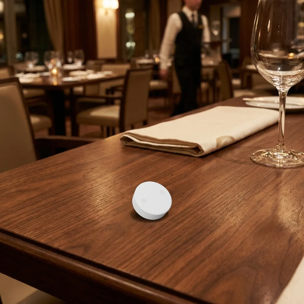 A Vycall B200 wireless call button on a restaurant table